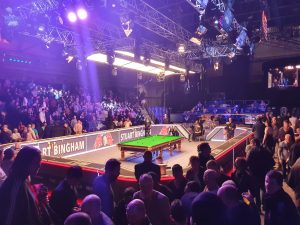 Photo of the snooker arena at Alexandra Palace with a snooker table in the middle an spectators around it